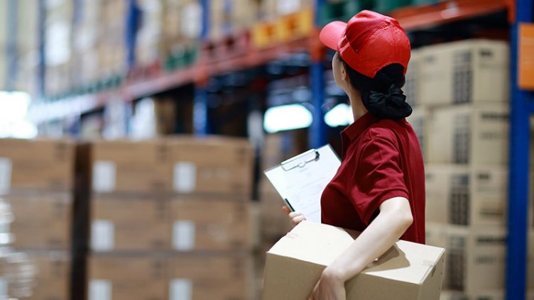 A warehouse worker surveying the warehouse floor