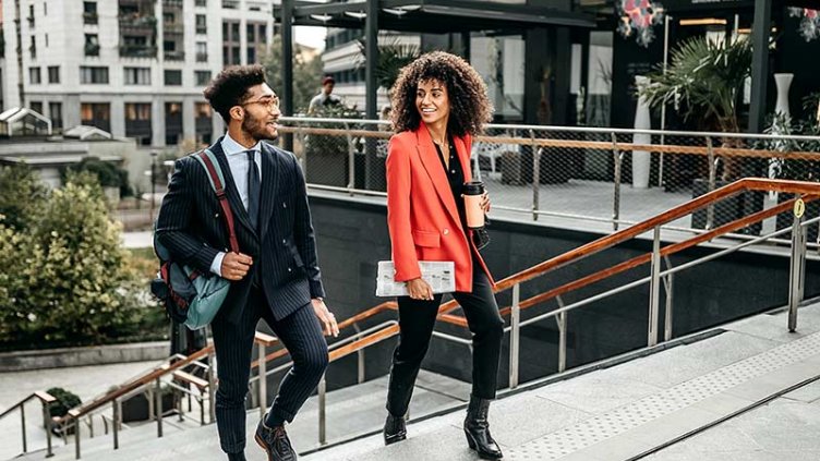 Two business people walking up stairs to the office