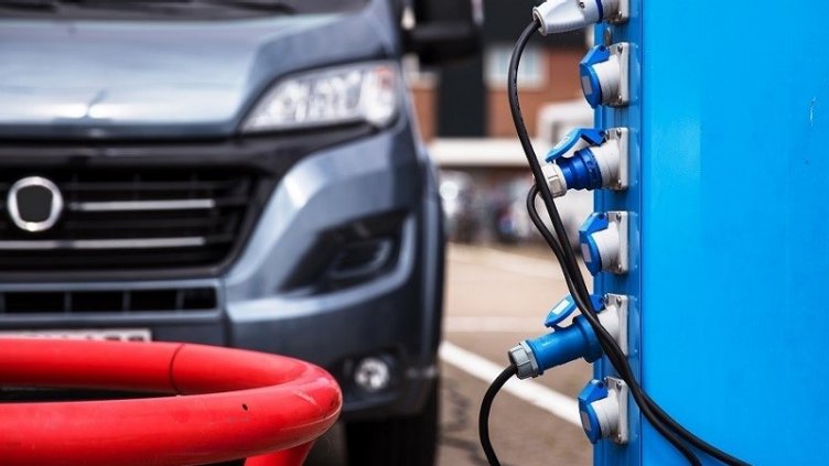 car waiting for electric vehicle charging station