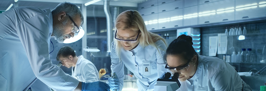 A team of scientists working in a life sciences research laboratory.