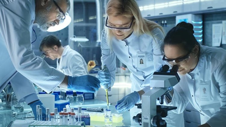 A team of scientists working in a life sciences research laboratory.