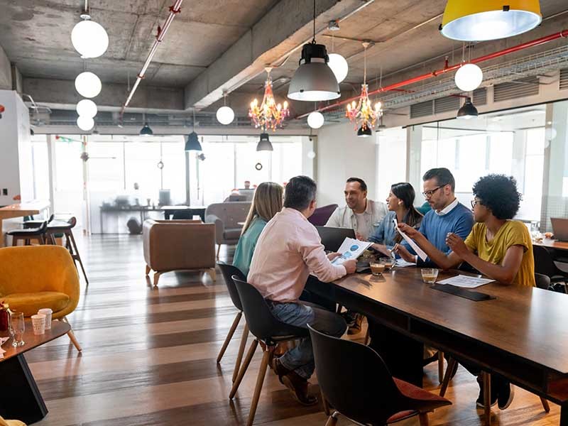 Team meeting in a modern office with multiple types of furniture